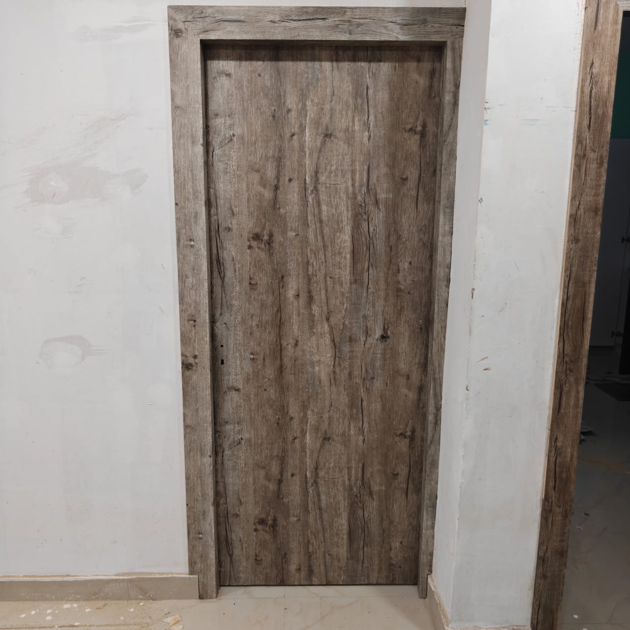 Solid wood interior door with natural grain finish by Mannat Interior
